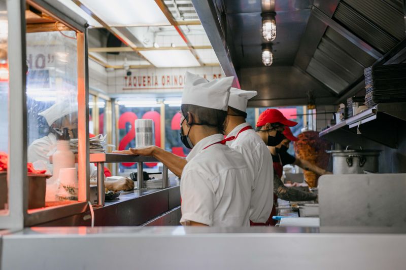 Dave's hot chicken kitchen with hand-breaded crispy chicken being prepared
