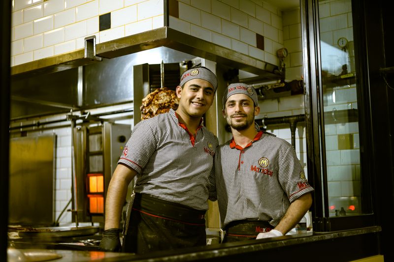 Dave's hot chicken team members working together in a vibrant kitchen